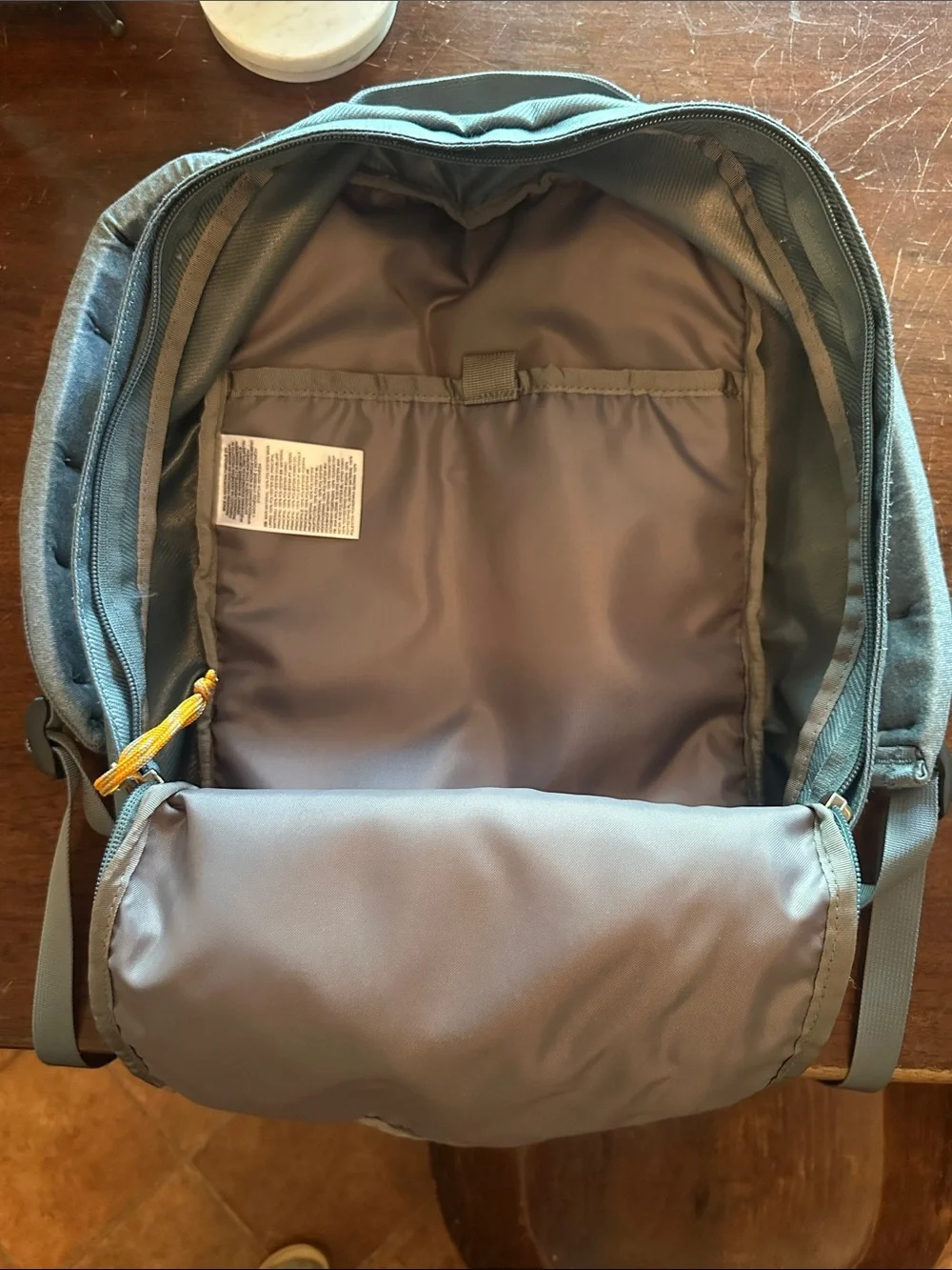 The North Face Light Blue Backpack with White Base and Yellow Accents